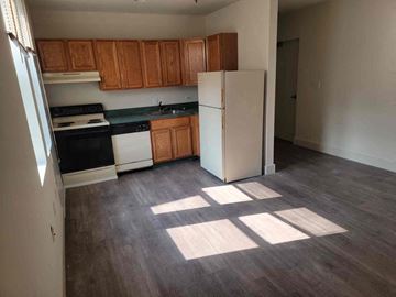 Philadelphia apartment for rent - a kitchen with wooden floors and a white refrigerator