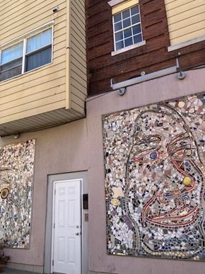 Philadelphia apartment for rent - a building with a mosaic mural and a white door