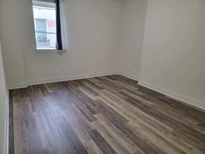 Philadelphia apartment for rent - a bedroom with wood flooring and a window