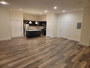 Philadelphia apartment for rent - a kitchen and living room with wood flooring in an empty apartment