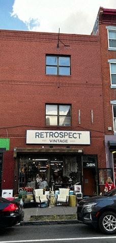 Philadelphia apartment for rent - a red brick building with a store sign on the front of it