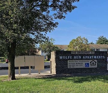 Hughesville apartment for rent - a sign for the wolfe run apartments in front of a tree