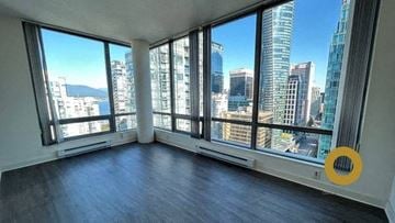 Vancouver house for rent - an empty living room with a view of the city