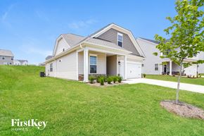 Greenville house for rent - a white house with a yard in front of it
