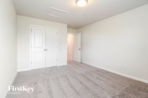 Greenville house for rent - a bedroom with a carpeted floor and white doors