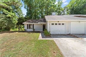 Jacksonville house for rent - a white house with a garage and a lawn