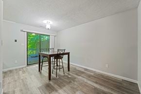 Jacksonville house for rent - a dining room with a table and chairs next to a sliding glass door