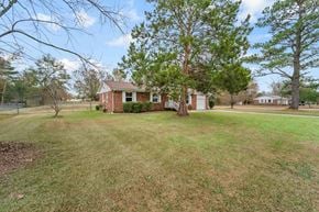 Jacksonville house for rent - a brick house with a large yard and trees