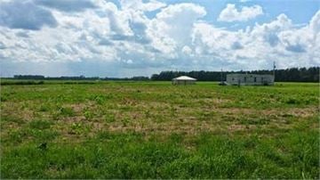 Chadbourn house for rent - a field of grass with a building in the middle of it