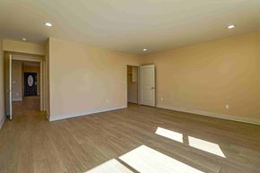 Inglewood apartment for rent - an empty living room with wooden floors and a white door