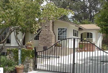 Solana Beach apartment for rent - A house with a black gate and a tree in front.