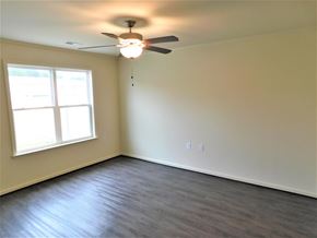 Midway Park house for rent - A room with a ceiling fan and a window.