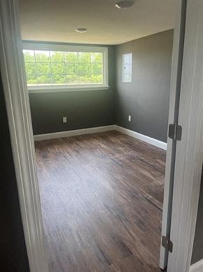 Chadbourn house for rent - a empty room with wood floors and a window