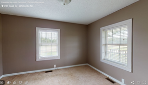 Whiteville house for rent - a bedroom with two windows and a carpeted floor