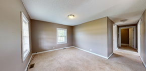 Whiteville house for rent - an empty living room with a door to a hallway