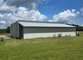 Chadbourn apartment for rent - A large metal building with a white painted wall at its base.