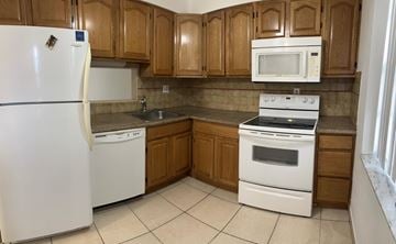 Lauderdale Lakes apartment for rent - A kitchen with white appliances and wooden cabinets.