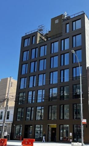 Queens apartment for rent - a tall building with a street light in front of it