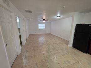 Fort Myers apartment for rent - A room with a ceiling fan and tile flooring.