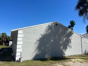 Fort Myers apartment for rent - A white building with a shadow cast on it.