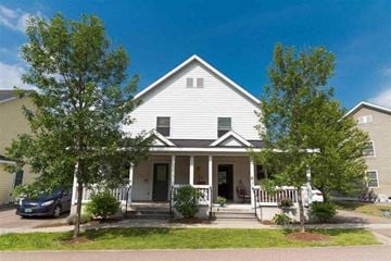 Stowe apartment for rent - A house with a white front porch and a tree in front.
