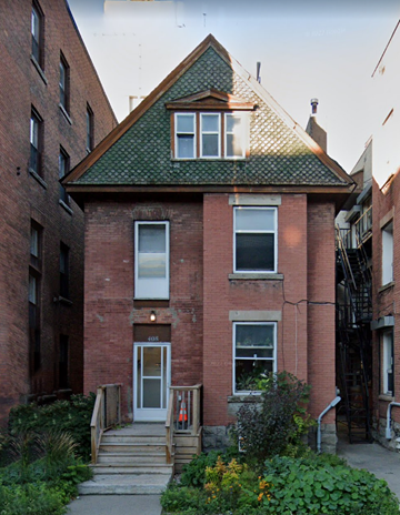 Ottawa apartment for rent - a small brick house with a green roof and stairs