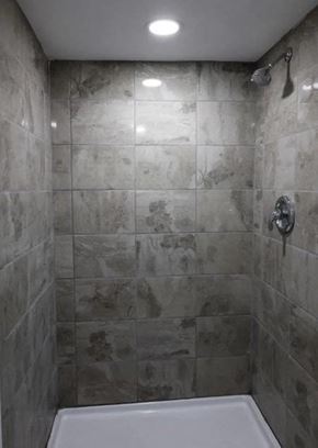 Hammond house for rent - a tiled bathroom with a shower and a sink