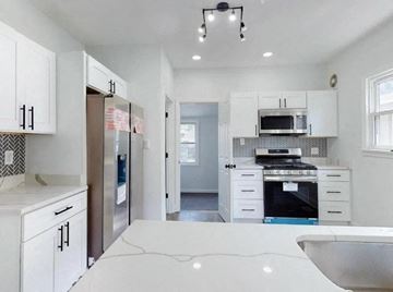 Hammond house for rent - a white kitchen with a sink and a refrigerator