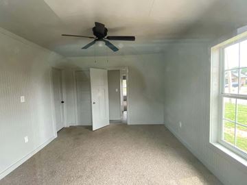 Littlefield house for rent - a living room with a ceiling fan and a carpet