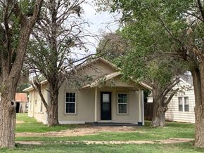 Littlefield house for rent - a small white house with trees in front of it