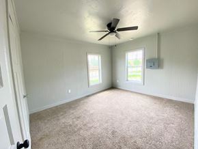 Littlefield house for rent - a living room with a ceiling fan and a carpeted floor