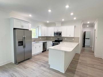 Saratoga Springs apartment for rent - a kitchen with white cabinets and stainless steel appliances