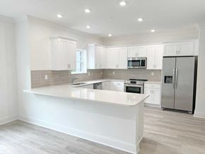 Saratoga Springs apartment for rent - a white kitchen with a large island and stainless steel appliances