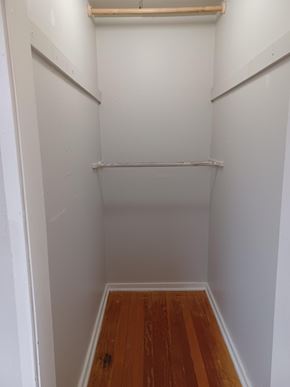 Soap Lake house for rent - A small white closet with a wooden shelf and a wooden floor.