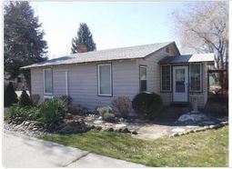 Soap Lake house for rent - A small house with a grey roof and a white door.
