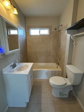 Soap Lake house for rent - a bathroom with a toilet and a sink and a bath tub