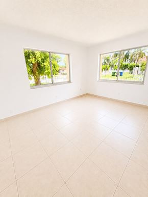 Hallandale Beach apartment for rent - Empty room with two windows and tiled floor.