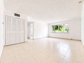 Hallandale Beach apartment for rent - A room with a white ceiling, a white door, and a white cabinet.