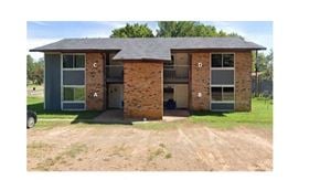 Hughes Springs house for rent - A house with a brick facade and a grey roof.
