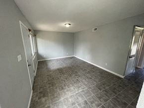 Hughes Springs house for rent - A room with tile flooring and white walls.