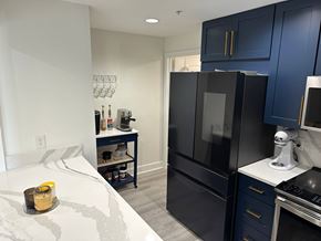 Bradenton house for rent - a black refrigerator freezer sitting in a kitchen next to a bed