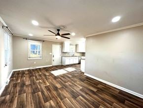 Mauldin house for rent - an empty living room with a ceiling fan and a kitchen