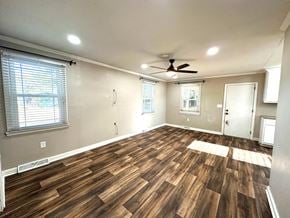 Mauldin house for rent - a living room with wood floors and a ceiling fan