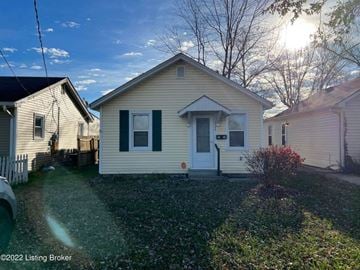 New Albany house for rent - a small white house with green shutters and a yard