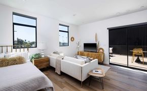 Ventura apartment for rent - A bedroom with a bed, a couch, a chair, and a television.