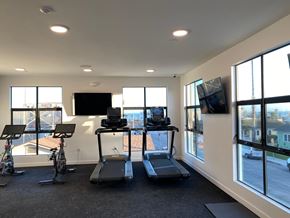 Ventura apartment for rent - A gym with treadmills, exercise bikes, and a television.