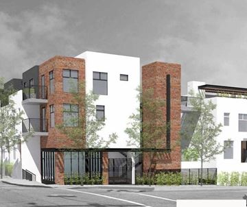 Ventura apartment for rent - A modern two-story building with a black and white exterior and a brick chimney.