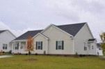 Goldsboro apartment for rent - A white house with a grey roof and a green lawn in front.