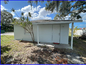 Palmetto apartment for rent - a small white house with a white door