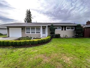Longview house for rent - A house with a grey roof and a white garage door.